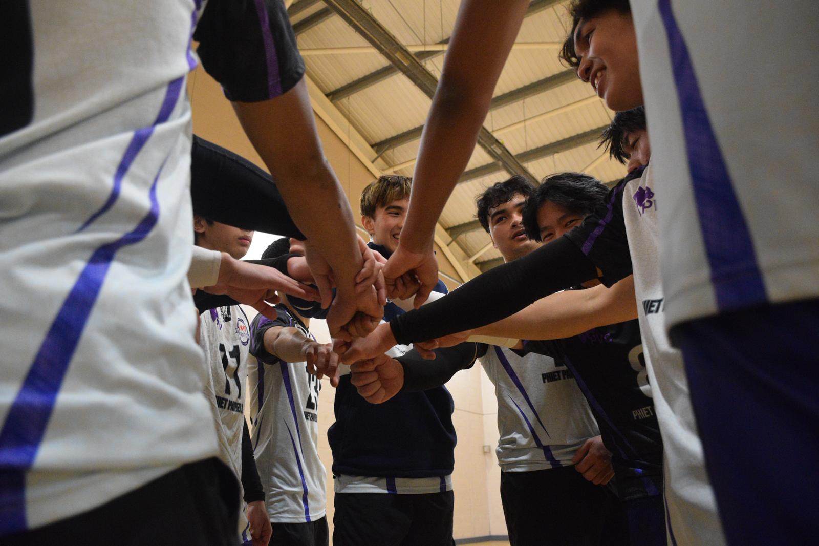 The Phiet Panthers team huddled together on court